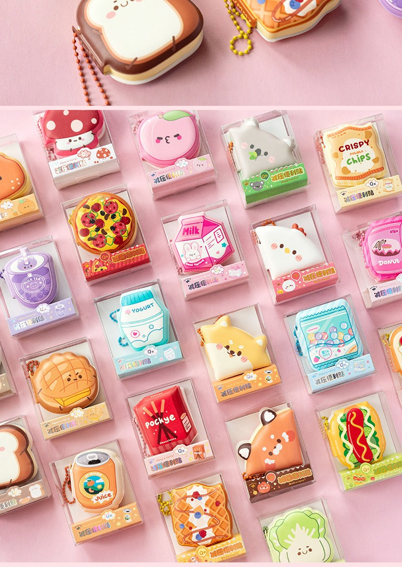 Collection of cute, cartoon-style food-themed mini sticky note pads on a pink background