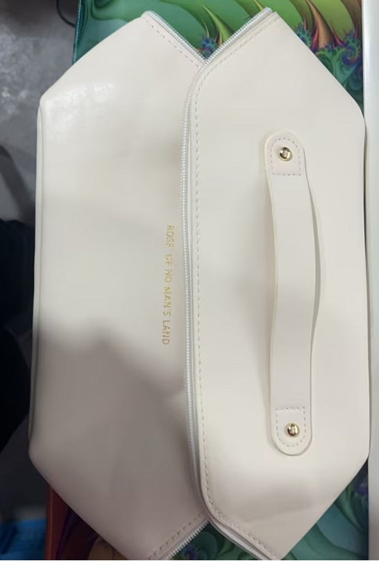 White handbag with gold text on a colorful background