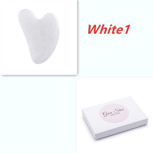 White Gua Sha tool with packaging on a white background