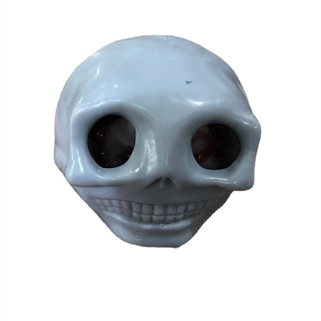 Skull-shaped fidget toy squishy stress relief on a white background