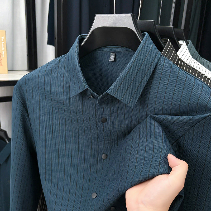 Blue ribbed shirt being held by a hand with a blurred background