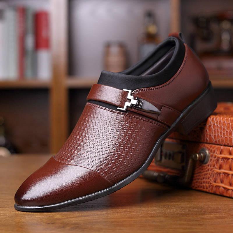 Brown leather shoe with a decorative buckle on a wooden surface