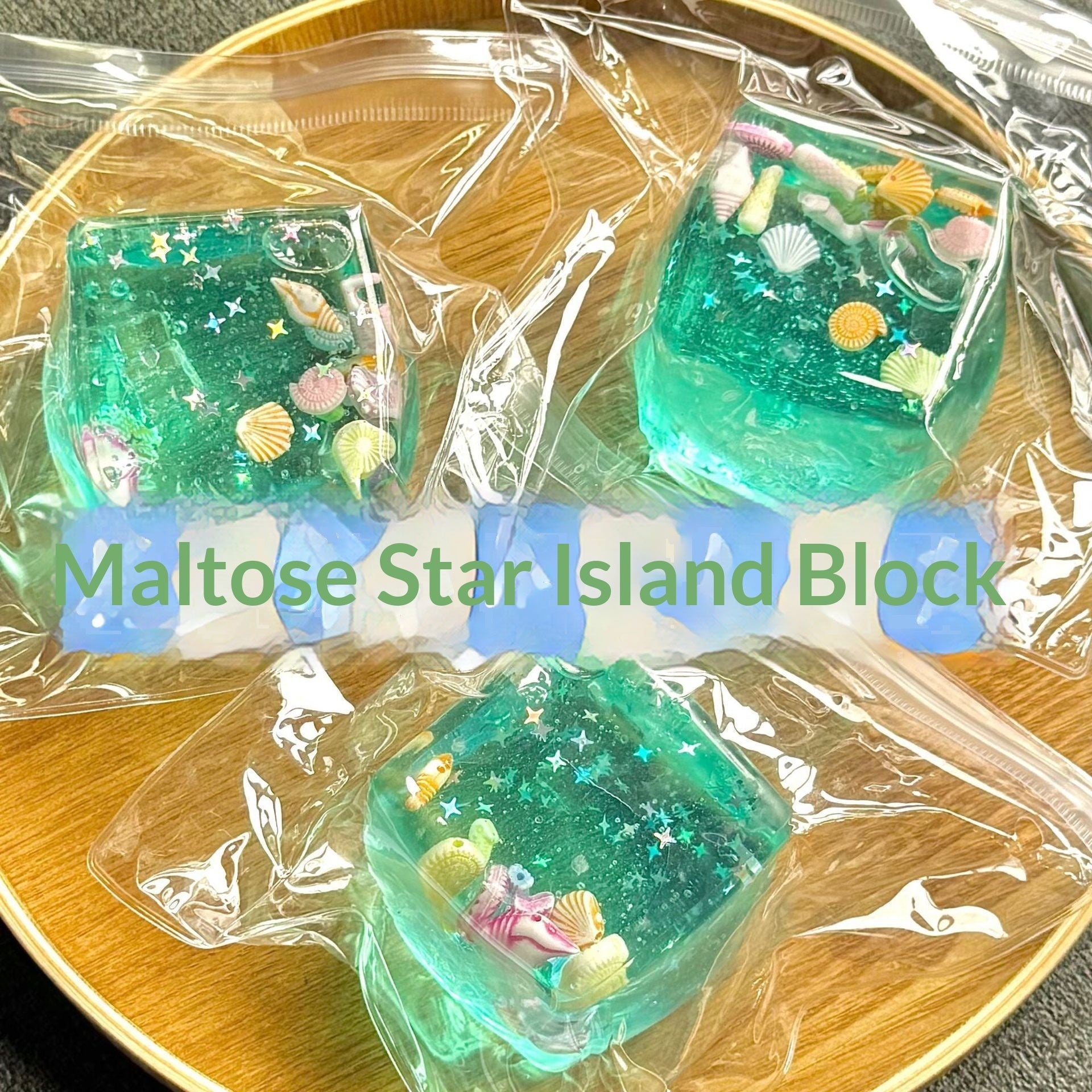 Green maltose star island blocks in clear packaging on a wooden surface