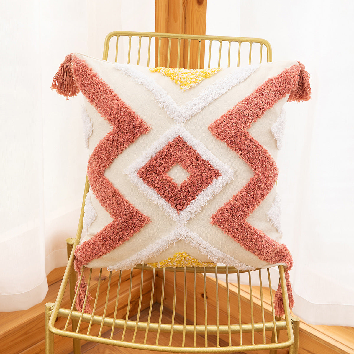 Decorative pillow with pink zigzag pattern on a gold chair