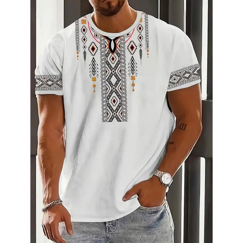 Man wearing a white t-shirt with intricate patterns, standing against a neutral background.
