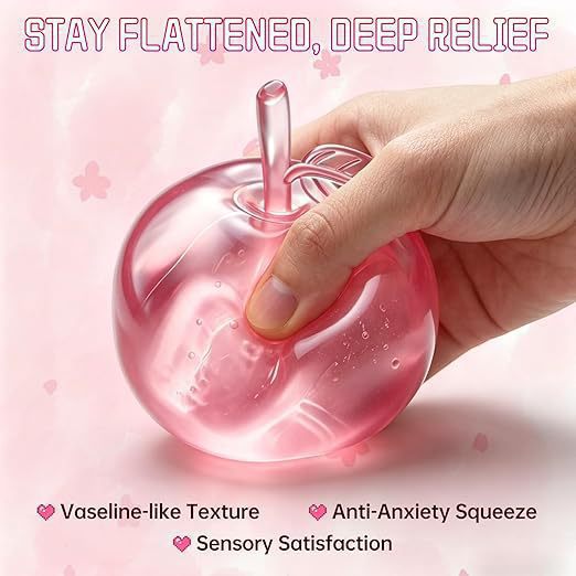 A translucent pink apple-shaped squishy toy being held by a hand against a soft pink background with text reading 'STAY FLATTENED, DEEP RELIEF' and feature callouts.