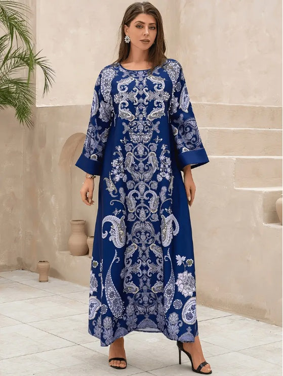 Woman wearing a blue and white patterned dress in an indoor setting.