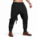 Black harem pants worn by a person on a white background