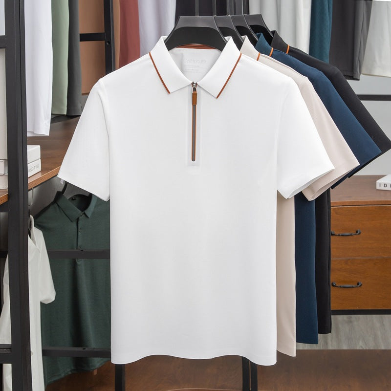 White polo shirt with brown zipper on a rack with other shirts in a clothing store.