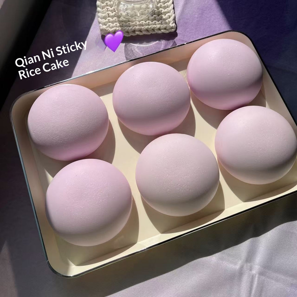 Pink rice cakes in a box with 'Qian Ni Sticky Rice Cake' text.