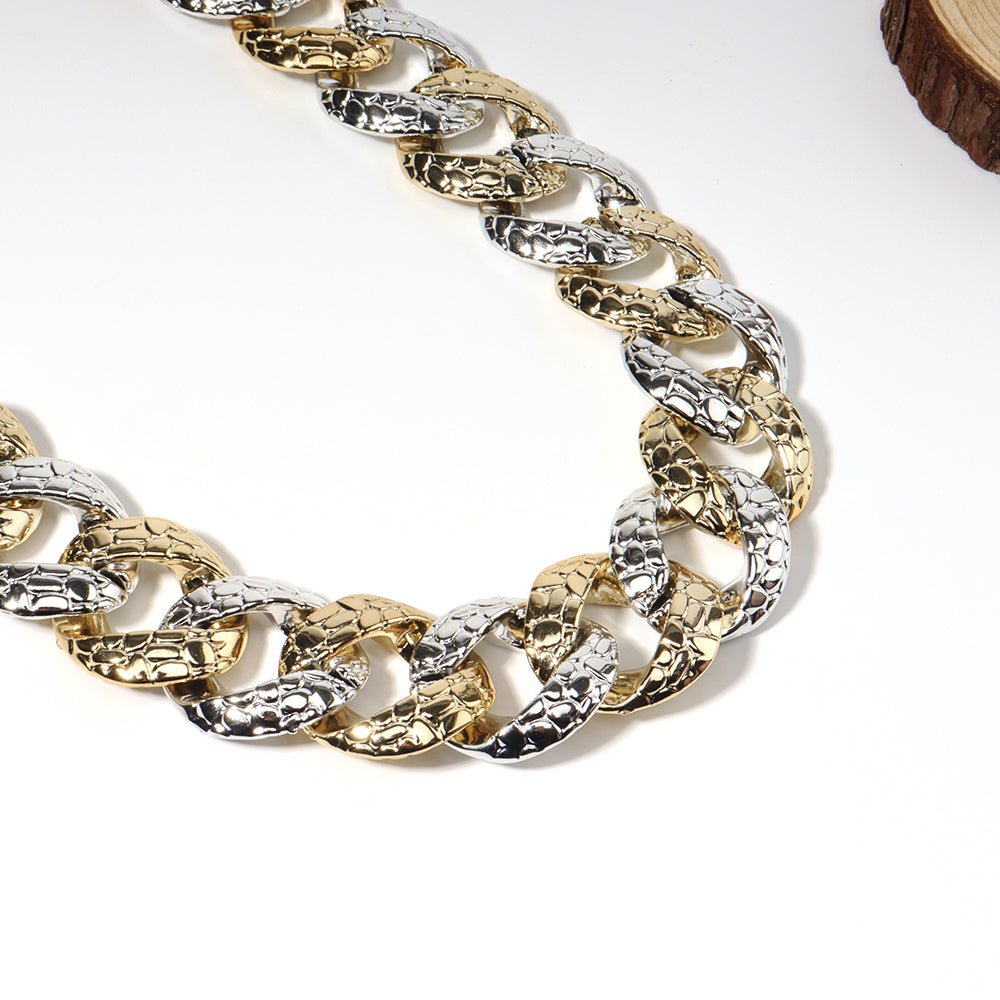Two-toned gold and silver chain on a white background