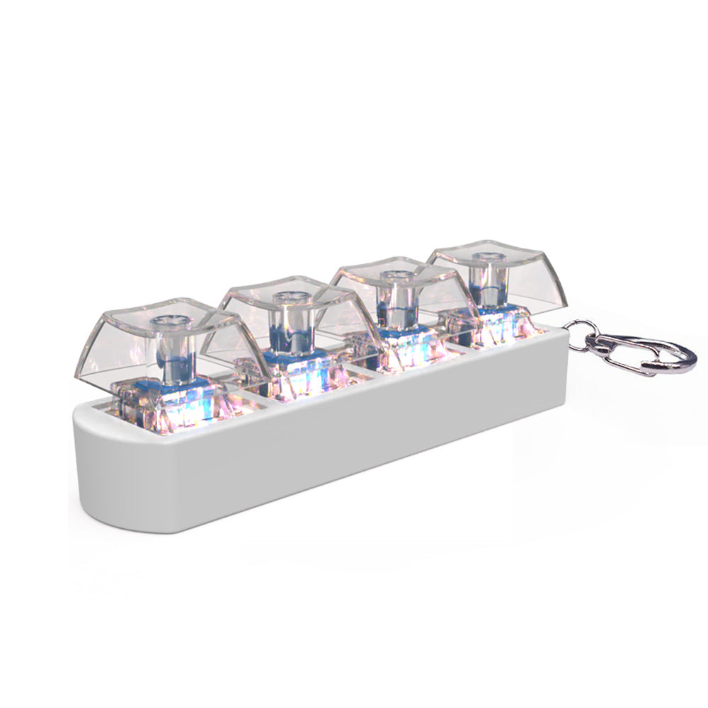 A white rectangular electronic keychain device with four clear dome-shaped covers over small illuminated internal components, shown on a plain white background with a metal key ring attached.