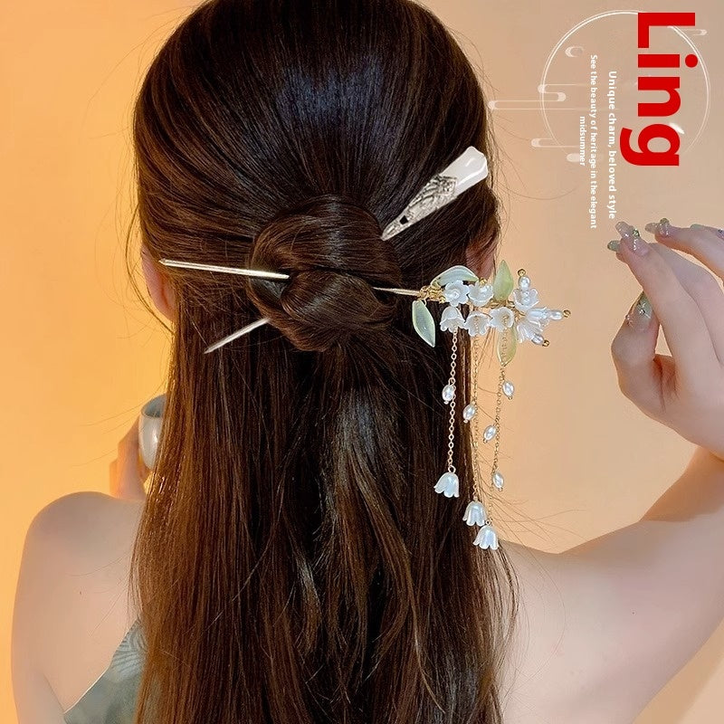 Woman with decorative hairpin in her hair against a warm orange background