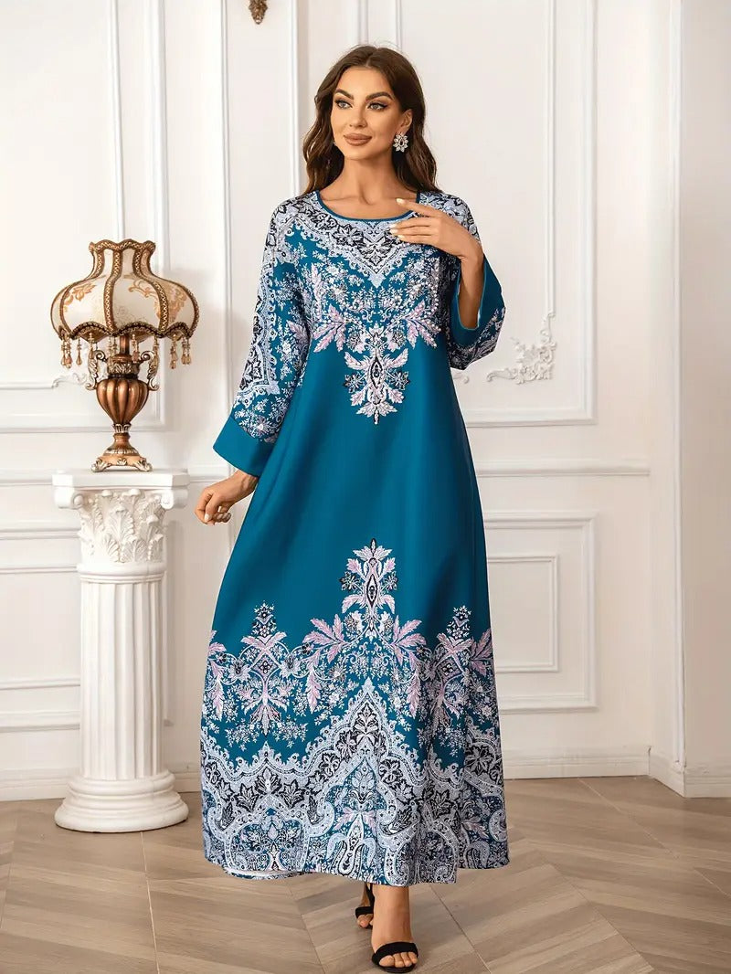 Woman wearing a blue dress with intricate patterns in an elegant room.