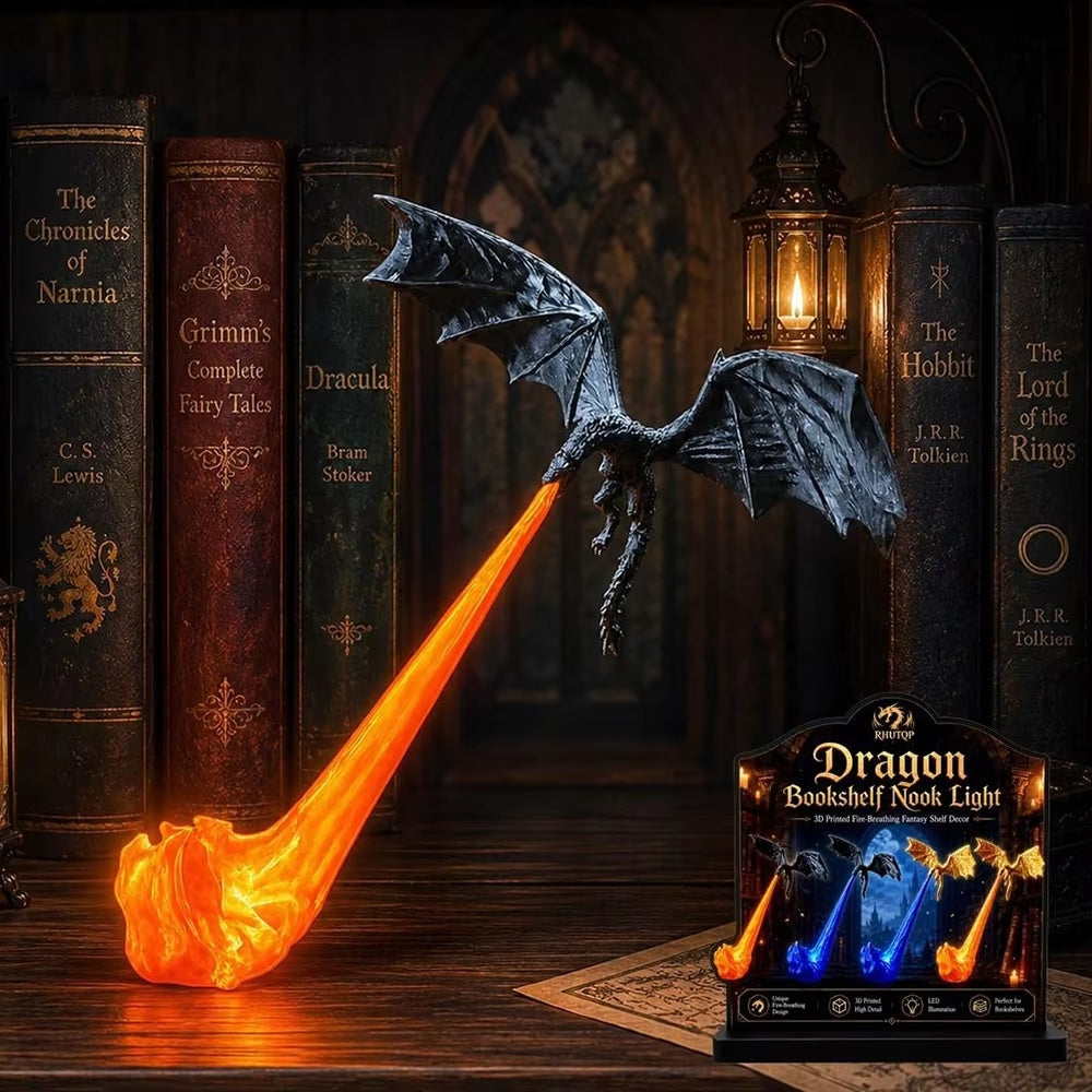 A dragon-shaped bookshelf night light with a glowing orange flame-like tail and dark wings, displayed beside a retail box on a wooden surface in front of vintage book spines and a lantern.