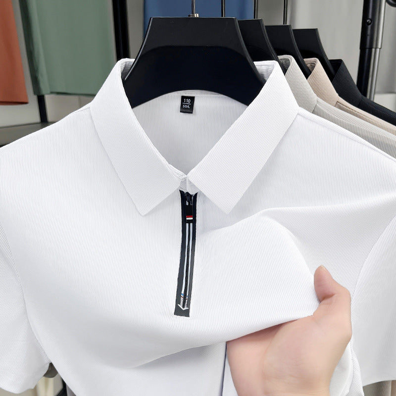 White shirt with a zipper held by a hand in front of a mirror reflection.