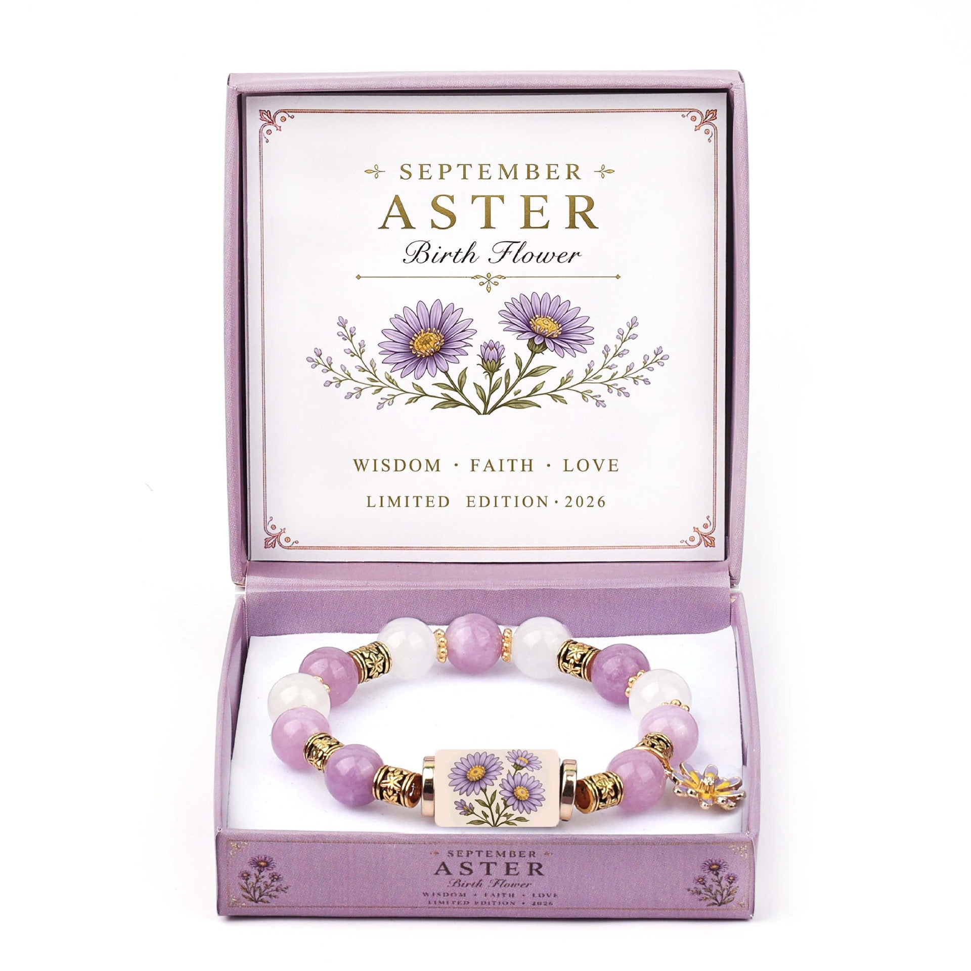 A beaded bracelet presented in an open lavender gift box. The bracelet features light purple and white beads with gold-toned spacer rings and a central floral charm.