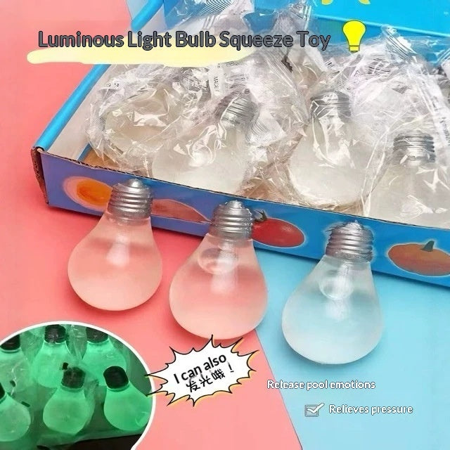 Luminous light bulb squeeze toy set shown with three clear glass light bulbs in front of a blue box containing more wrapped toys. The image includes text overlays describing the product and a circular inset showing glowing green light bulbs.