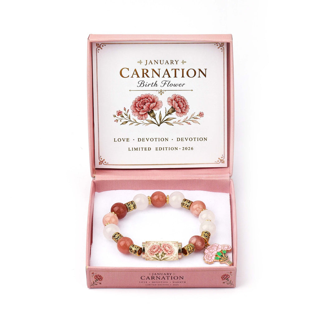 A beaded bracelet with pink and white stones and a floral charm, presented in a pink box labeled 'January Carnation Birth Flower' on a white background.
