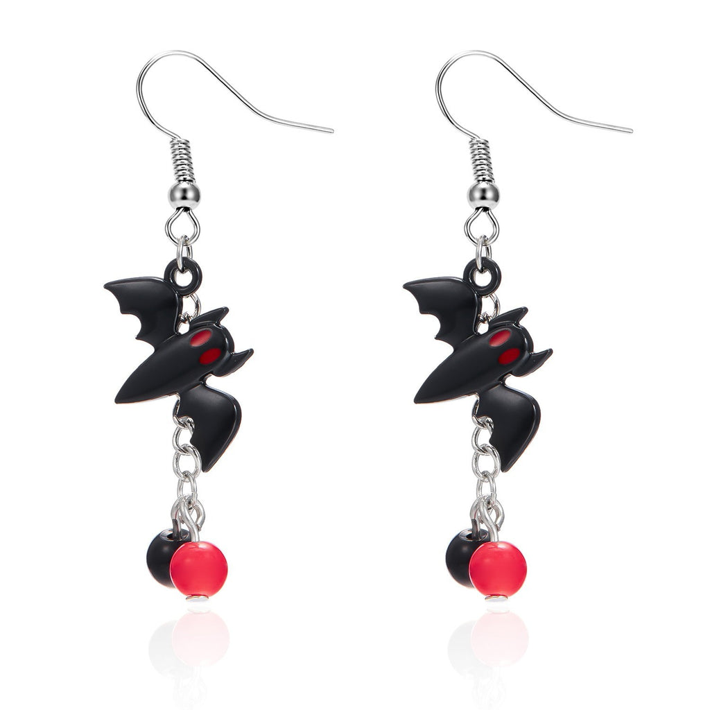 Black bat-shaped earrings with red accents on a white background
