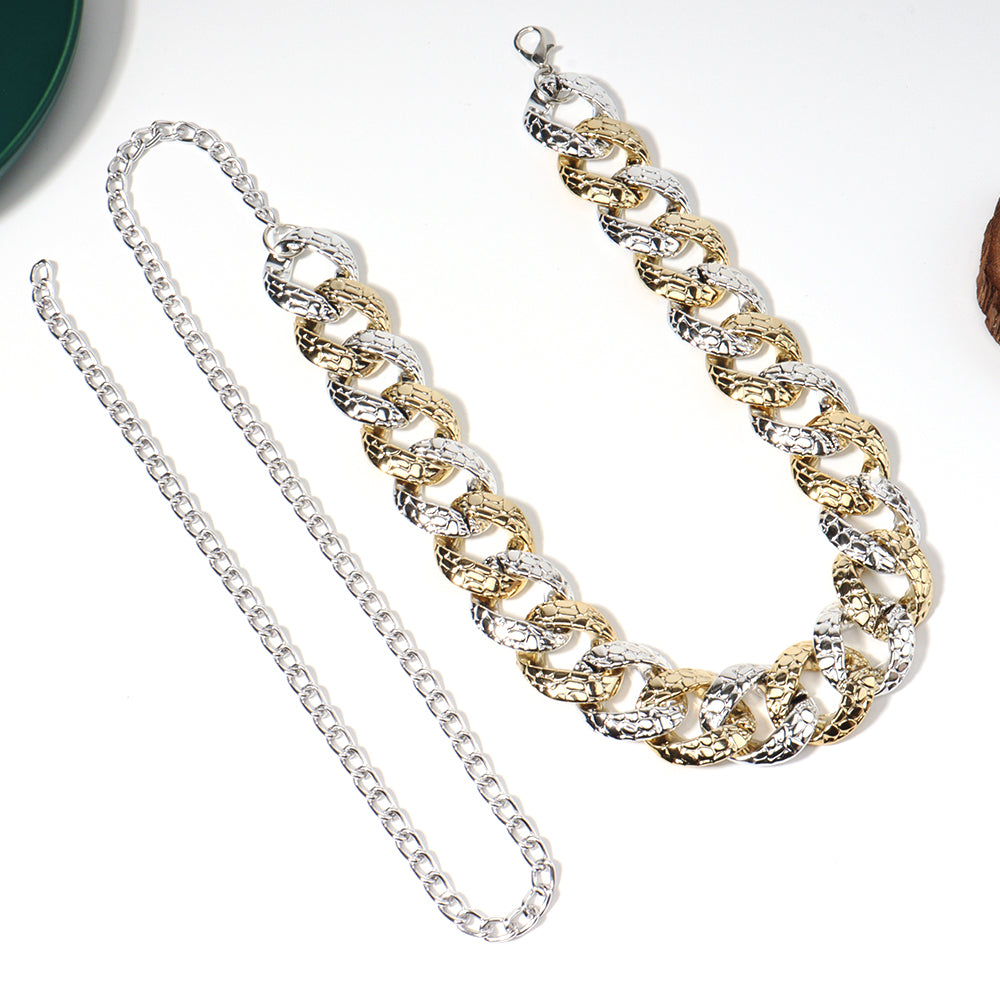 Two chain necklaces, one gold and one silver, on a white background.