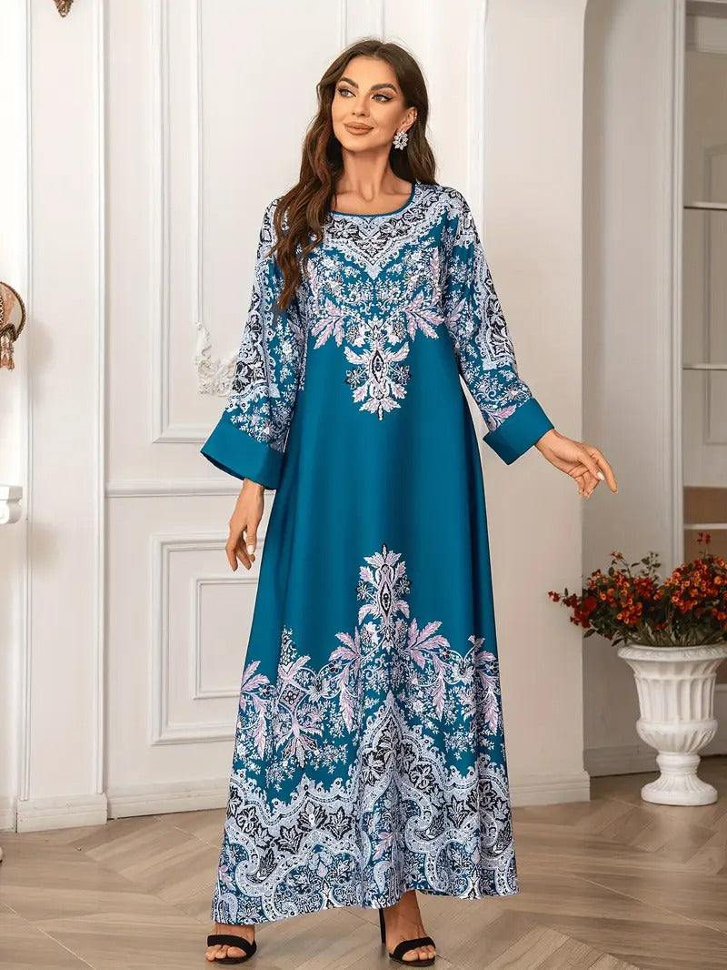 Woman wearing a blue and white patterned dress in an elegant room.