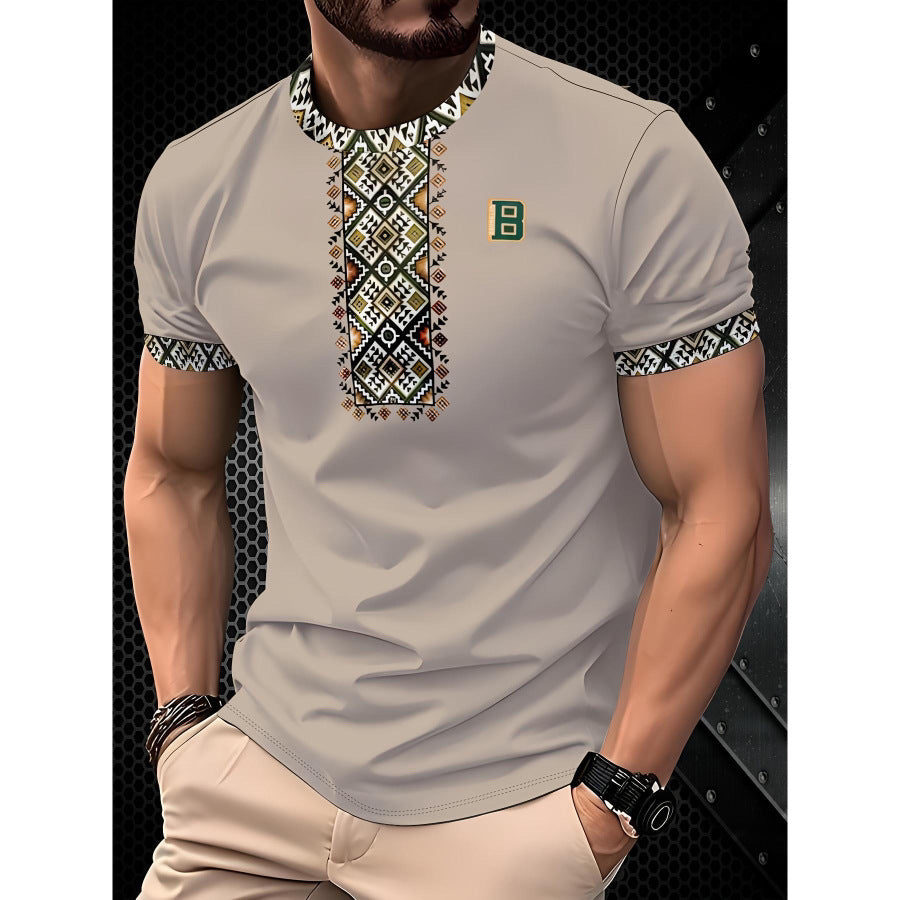 Man wearing a beige short-sleeve shirt with intricate patterns on a dark background