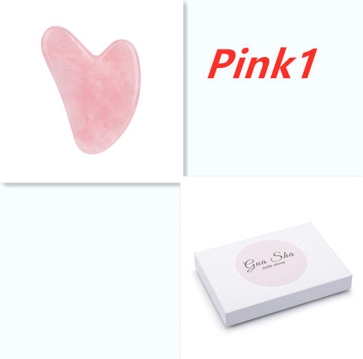 Pink gua sha tool with packaging on a white background