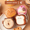Four cute dessert-shaped mini sticky note pads on a white plate with a brown background.