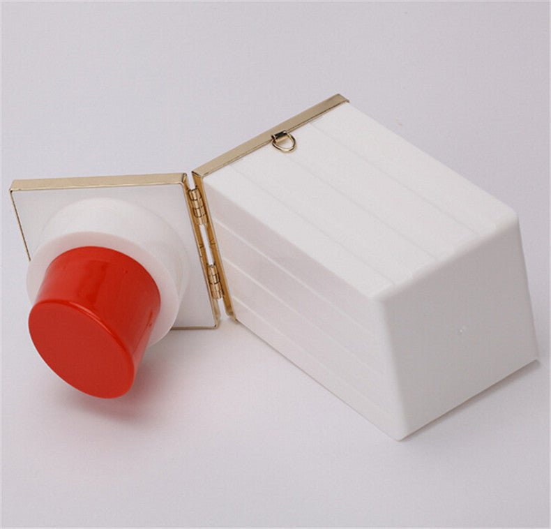 White compact mirror with red lip balm on a light gray background