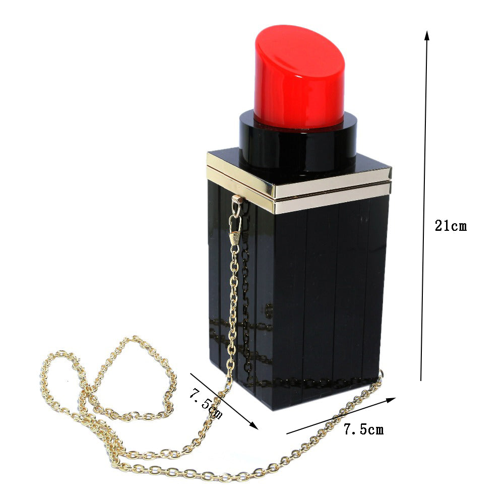 Black lipstick-shaped handbag with a red top and gold chain, shown with measurements on a white background.