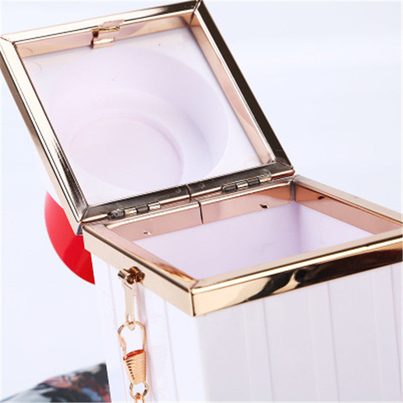 Rose gold compact mirror with a strap on a white background