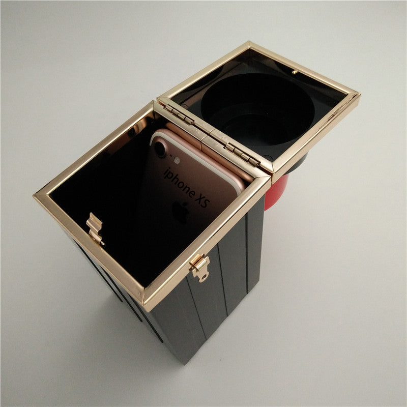 Phone case with 'iPhone XS' branding in a black and gold box on a gray background