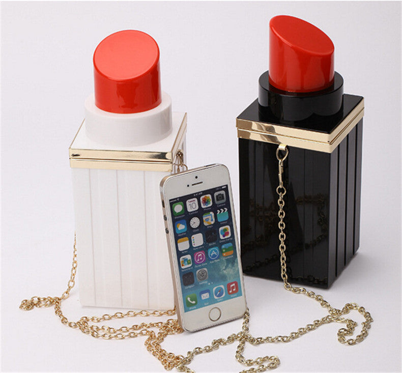 Two lip-shaped containers with red tops, one white and one black, each with a gold chain and smartphone inside.