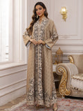 Woman in an elegant embroidered dress standing in a luxurious room with ornate furniture.
