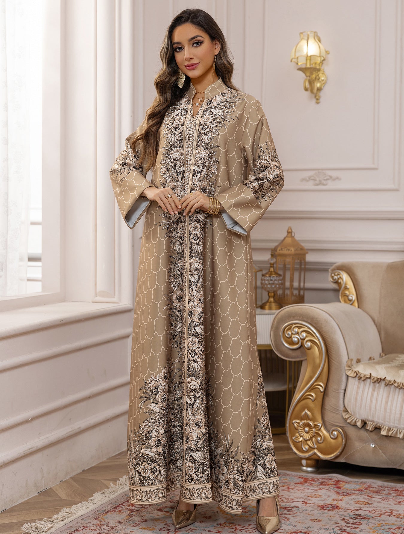 Woman in an elegant embroidered dress standing in a luxurious room with ornate furniture.