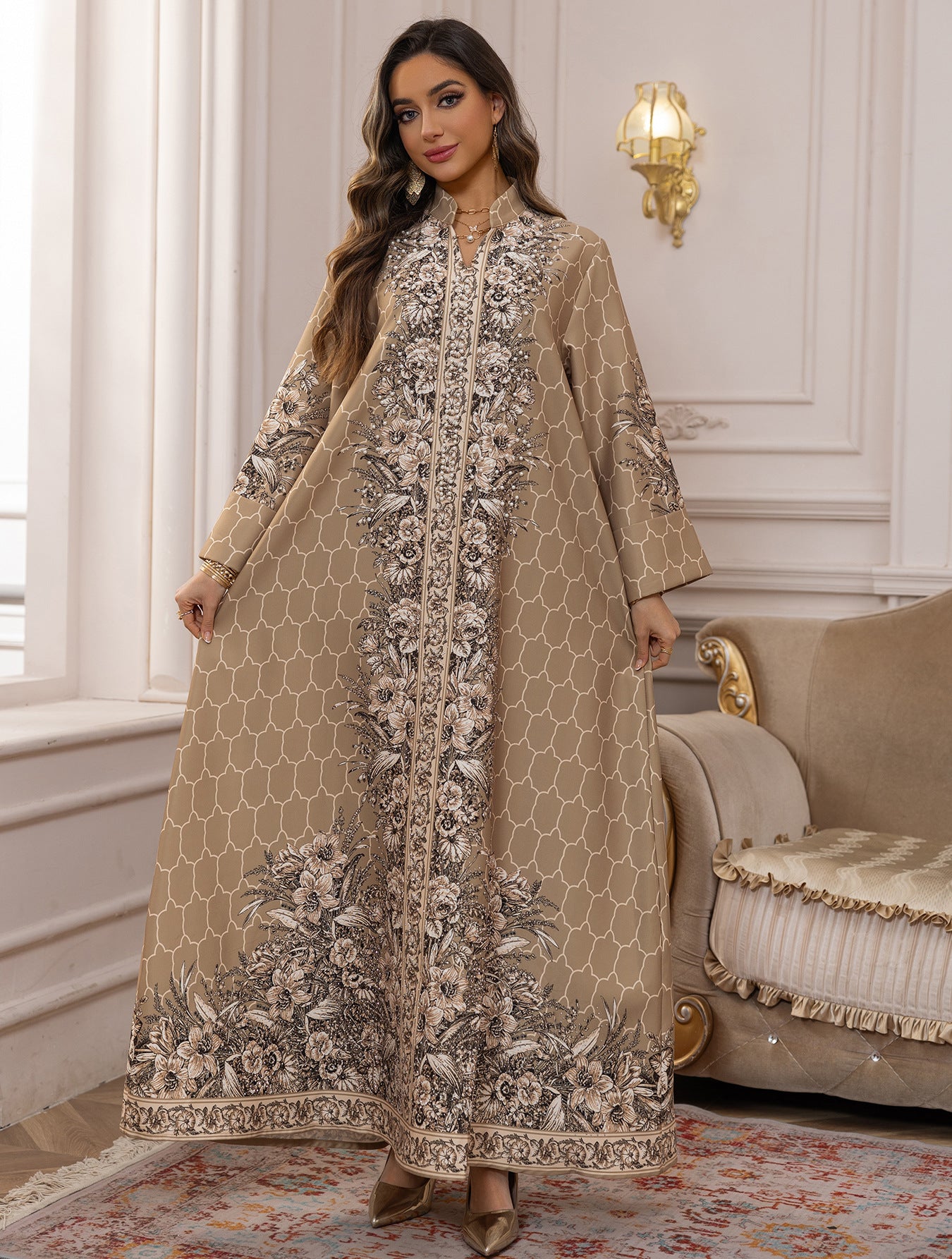 Woman wearing a beige embroidered dress in an elegant room.