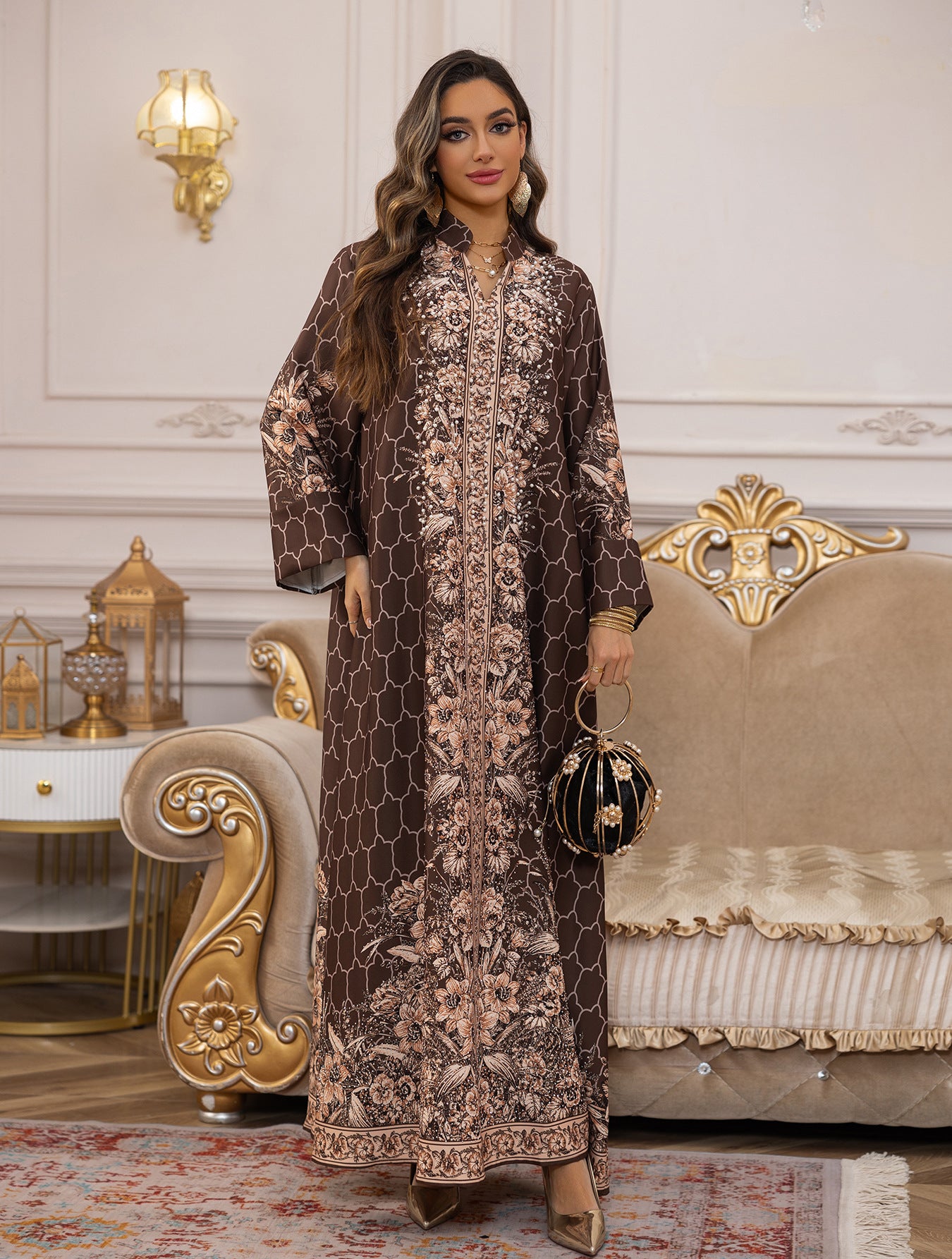 Woman in a patterned dress standing in an elegant room with decorative furniture.