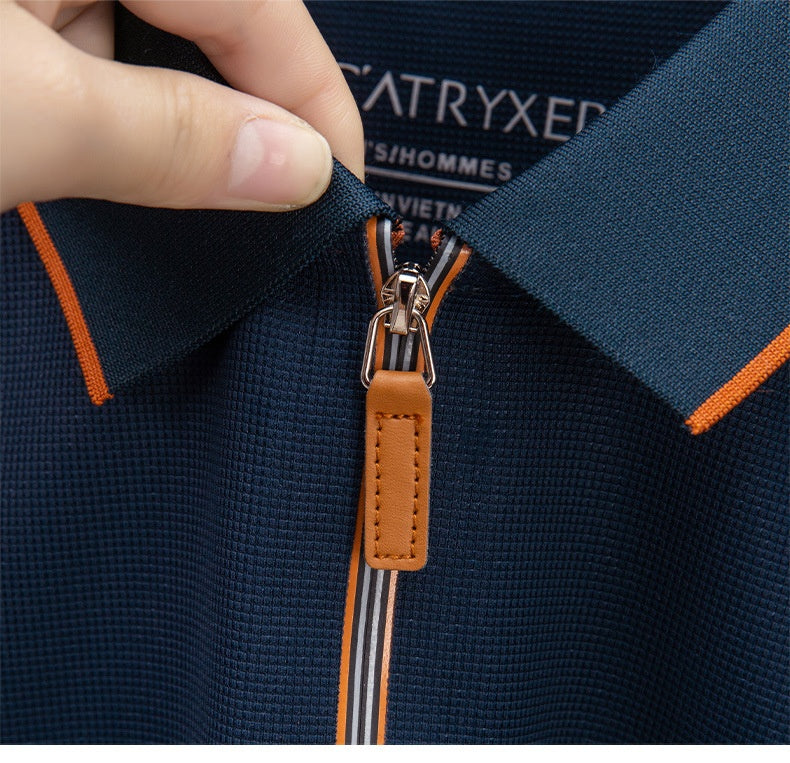 Close-up of a navy jacket with orange accents and a brown zipper, featuring the brand .