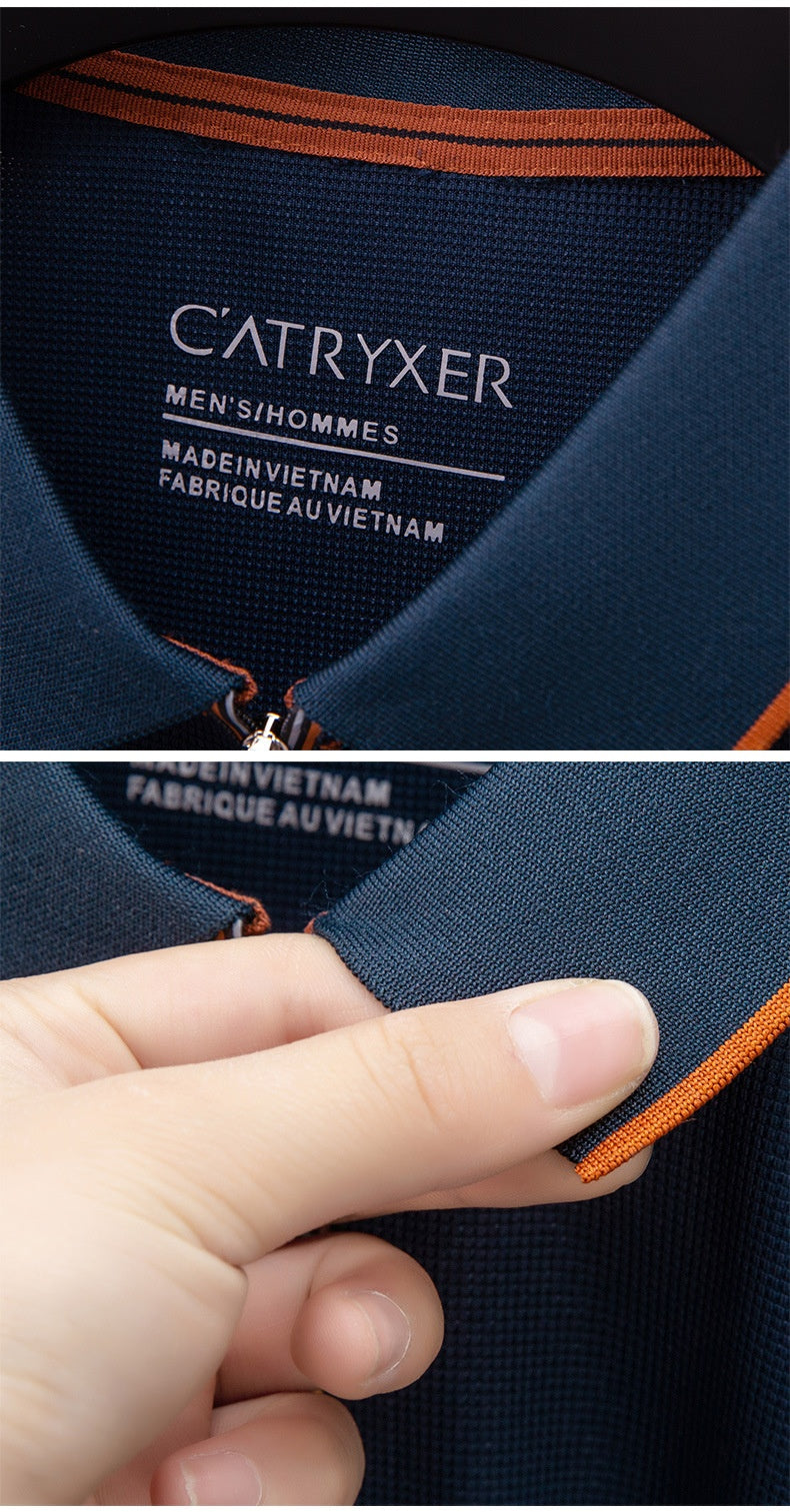 Close-up of a navy blue shirt with orange accents and 'Catryxer' branding.