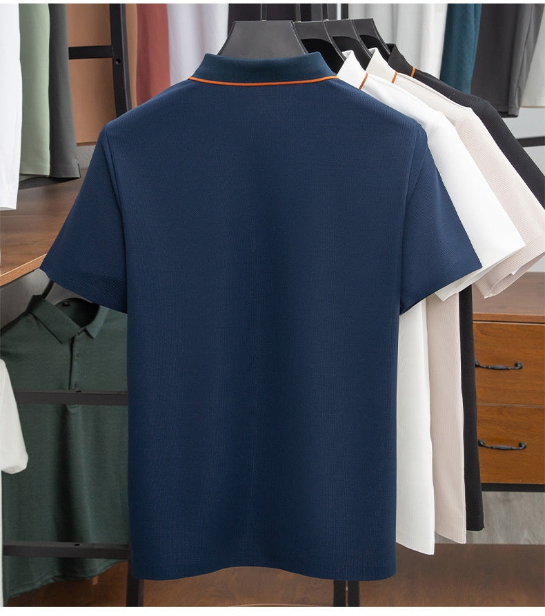 Navy blue polo shirt on a mannequin with other colored shirts in the background.